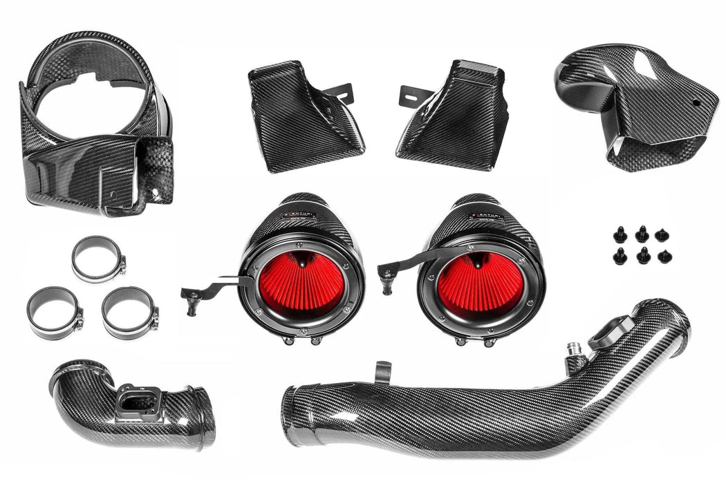 Eventuri F8X M3/M4 carbon fiber intake system components with red high flow filters and silicon couplers