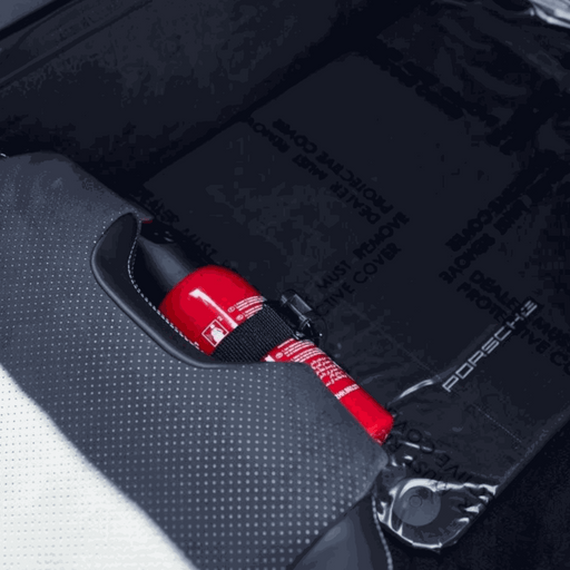 Porsche 992.2 carbon fiber bucket seat with OEM fire extinguisher kit installed