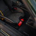 Porsche 992.2 folding carbon fiber bucket seat with OEM fire extinguisher kit and genuine Porsche mounting accessories